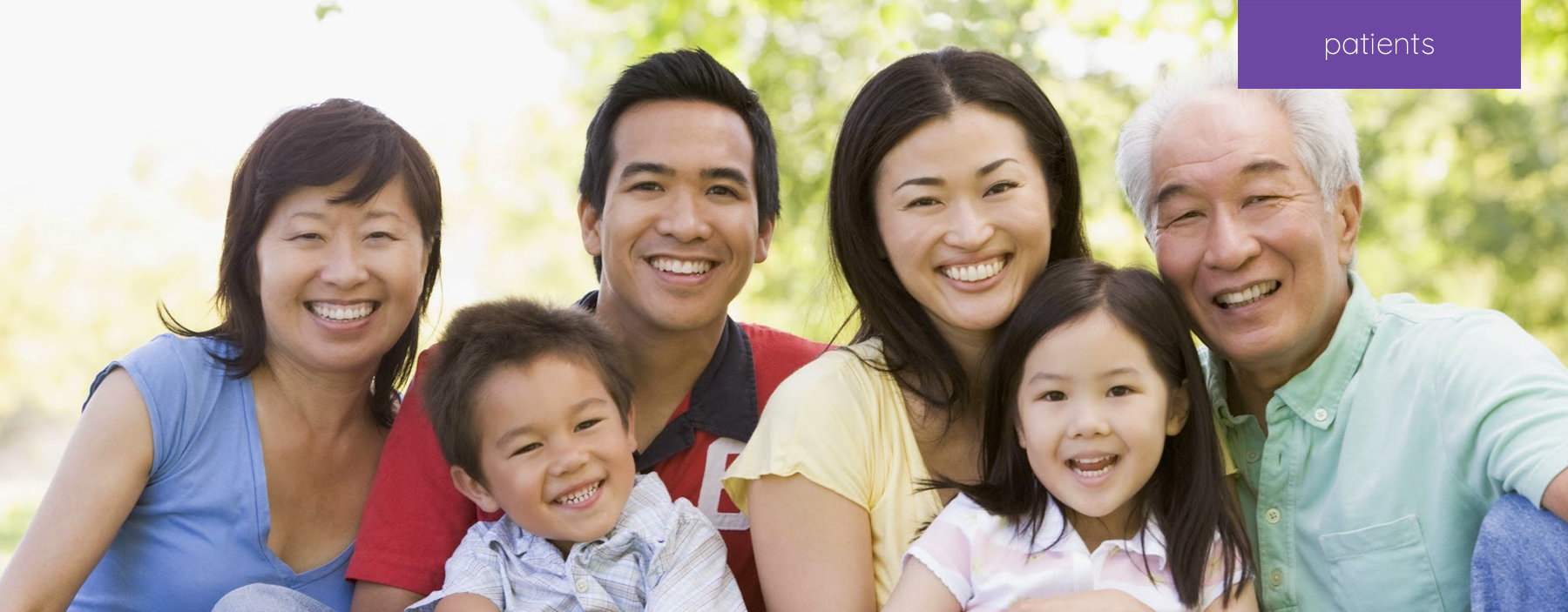 A family at the park smiling